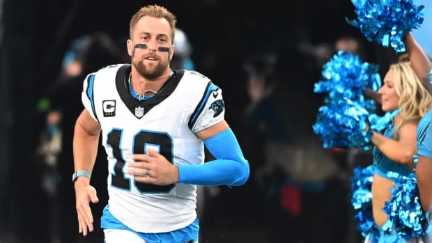 Panthers wide receiver Adam Thielen runs through the tunnel out onto the field before a game.